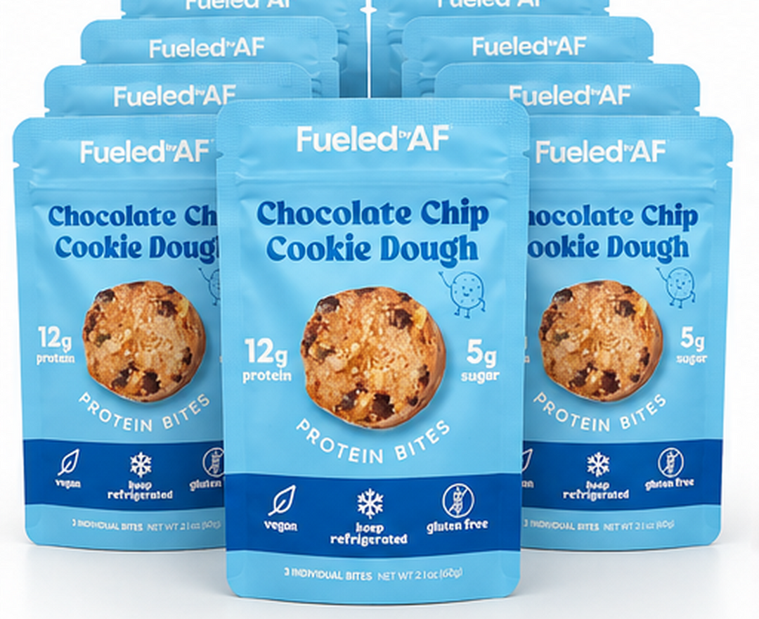 Three blue stand-up pouches of Fueled+AF Chocolate Chip Cookie Dough protein bites are arranged in a fan shape on a white background, with additional identical pouches visible behind them.